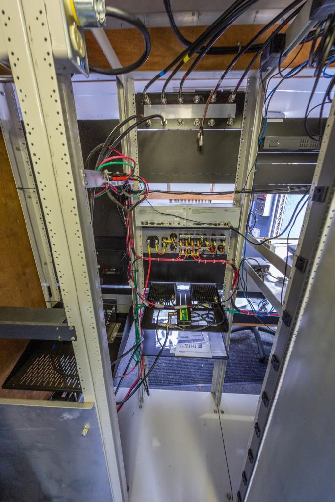 View of the back of the equipment rack, showing wiring.